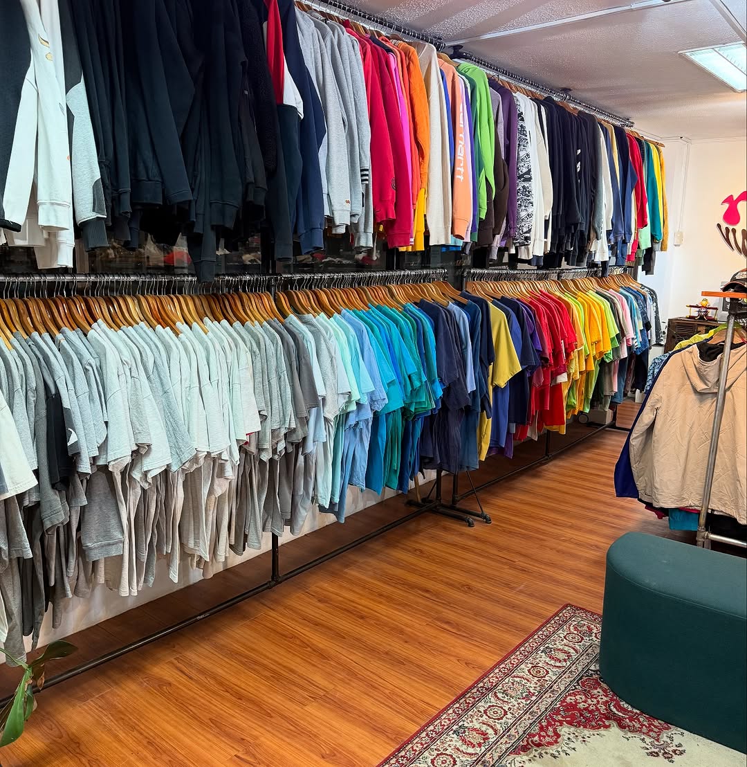 Y2K Vintage Cebu colour-sorted clothing racks — rainbow row of shirts and tops