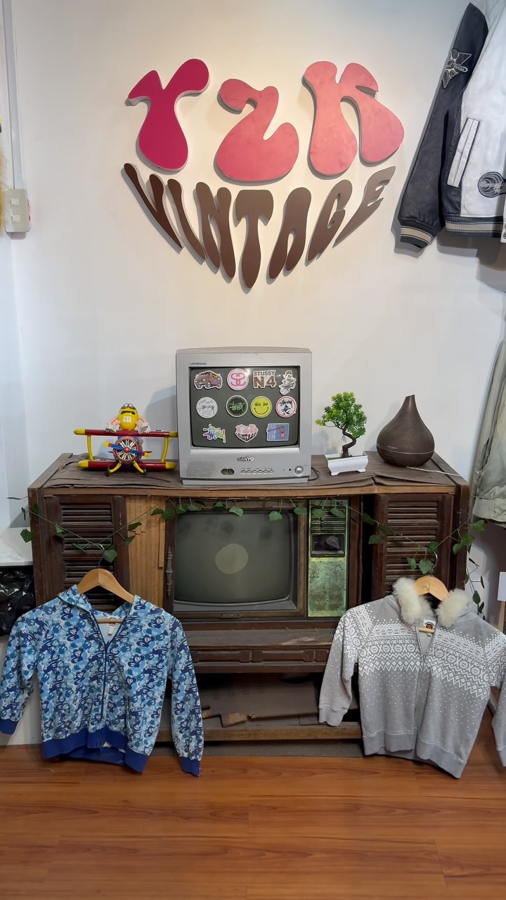 Y2K Vintage store interior with brand wall mural and vintage TV display